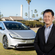 Chief engineer Satoki Oya standing in front of a silver 2023 Toyota Prius.